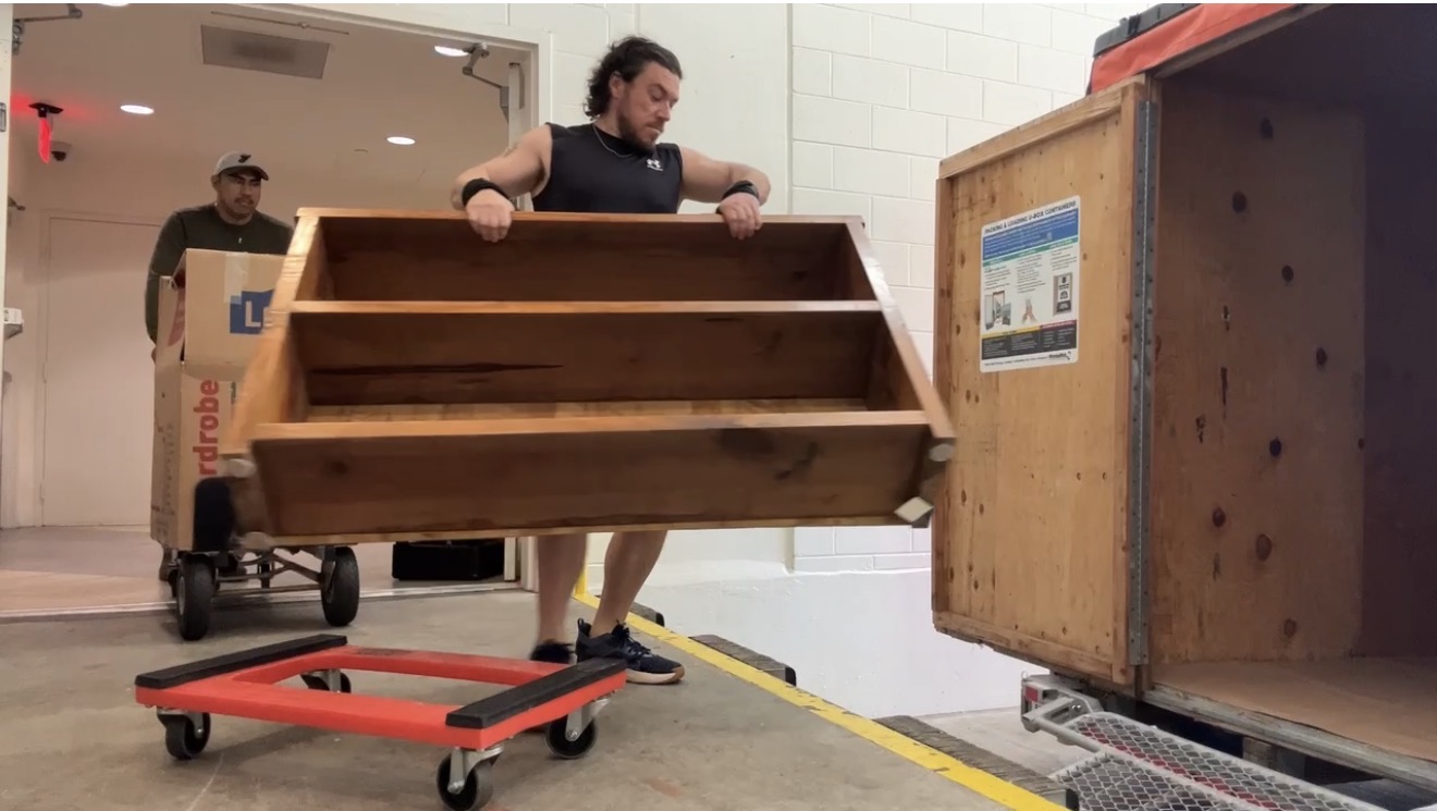 Liberty Movers crew loading a heavy wooden bookshelf into a moving truck in Huntington WV — professional furniture movers serving the Tri-State area